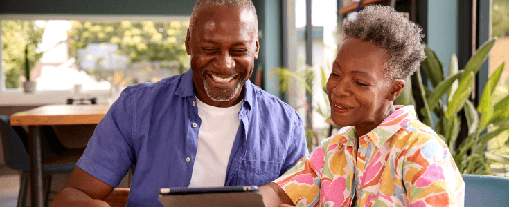 older couple on a tablet with loan application