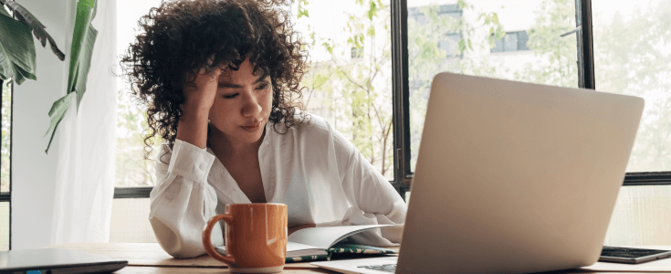 woman at her laptop with coffee mug