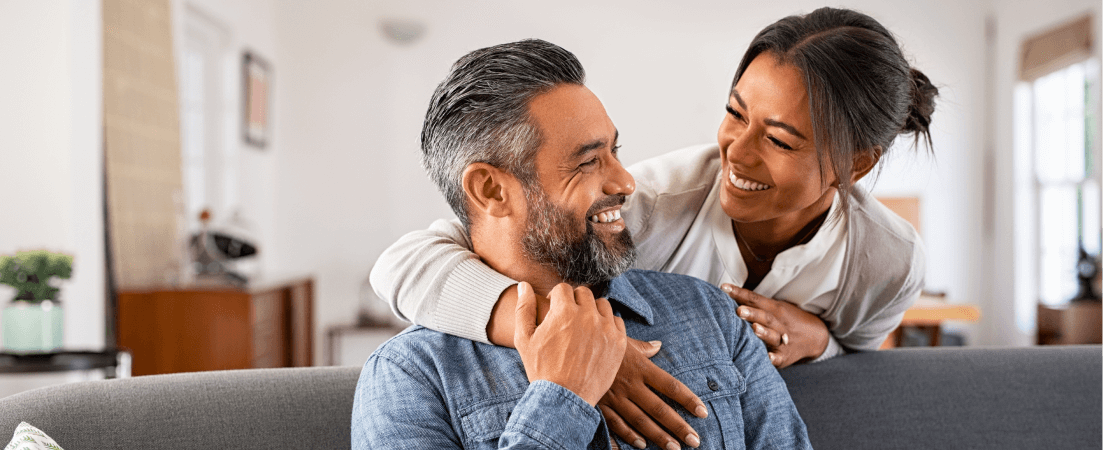 a couple embracing and smiling