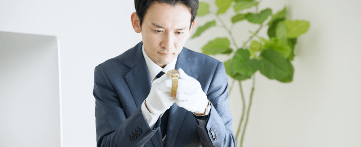 man examining a watch for a pawnshop loan