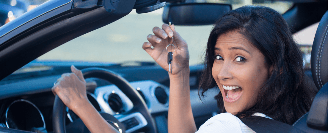 excited woman holding car keys