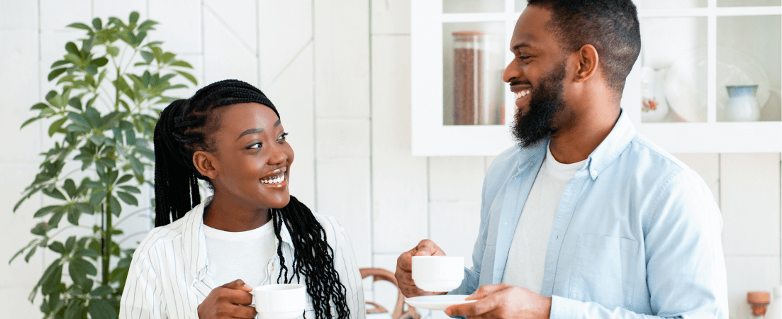 a couple chatting over coffee in their kitchen