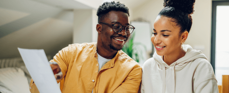 a couple looks at their loan application