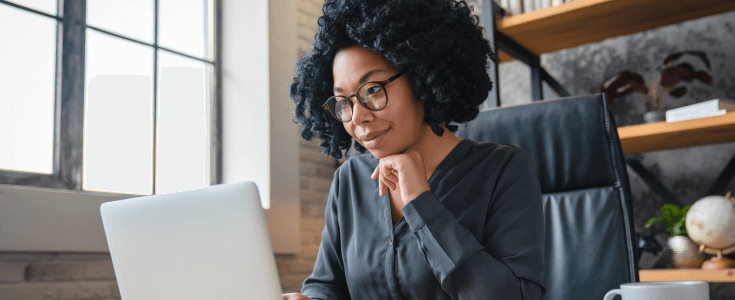 Woman at desk working on a laptop
