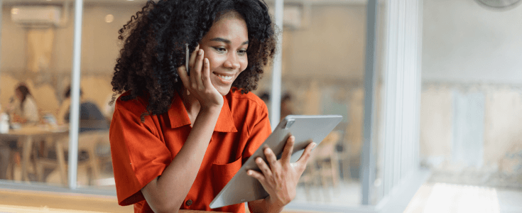 woman on her tablet smiles