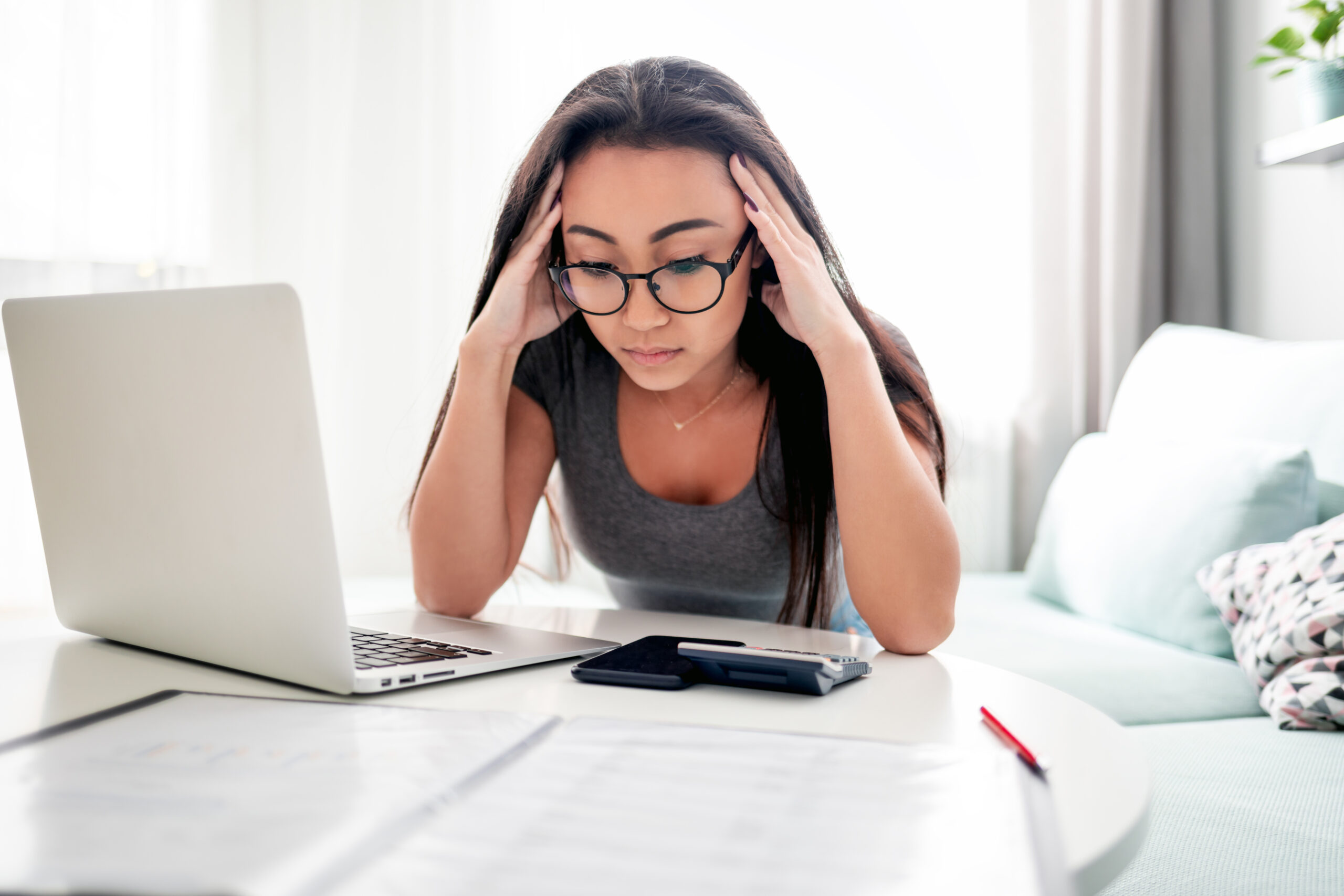 woman at laptop paying off debt